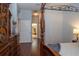 Hallway featuring hardwood floors, leading to a bathroom, connecting the bedroom and other living spaces at 8376 Golden Prairie Dr, Tampa, FL 33647