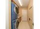 Practical laundry room features stacked washer and dryer along with ample storage at 8376 Golden Prairie Dr, Tampa, FL 33647