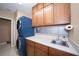 Well-equipped laundry area with blue washer/dryer, sink, cabinets and ample counter space at 8376 Golden Prairie Dr, Tampa, FL 33647