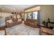 Inviting living room featuring hardwood floors and comfortable seating, open to kitchen, with sliding glass door and bright natural light at 8376 Golden Prairie Dr, Tampa, FL 33647