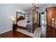 Spacious main bedroom boasting hardwood floors, a four-poster bed, and sliding glass doors leading to a pool area at 8376 Golden Prairie Dr, Tampa, FL 33647