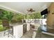 Outdoor kitchen featuring bar seating and stainless steel appliances at 8376 Golden Prairie Dr, Tampa, FL 33647