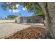 A backyard featuring a screened-in pool, a brick patio, mature trees, and a privacy fence at 930 Balsamina Dr, Brandon, FL 33510