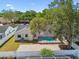 A backyard view of a screened-in pool area with brick patio and mature trees at 930 Balsamina Dr, Brandon, FL 33510