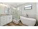 Bathroom with a glass shower, soaking tub, and a modern vanity with double mirrors at 930 Balsamina Dr, Brandon, FL 33510