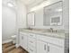 Bright bathroom featuring a double vanity, a large mirror, and a separate toilet area at 930 Balsamina Dr, Brandon, FL 33510
