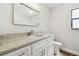 Bathroom featuring granite countertop, white cabinets, and modern fixtures at 930 Balsamina Dr, Brandon, FL 33510