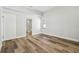 Bright bedroom featuring wood-look floors, a door to the bathroom, a window, and neutral walls at 930 Balsamina Dr, Brandon, FL 33510