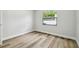 Bedroom with luxury vinyl plank flooring and bright window view at 930 Balsamina Dr, Brandon, FL 33510
