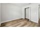 Bedroom with wood floors, neutral paint, and a double door closet at 930 Balsamina Dr, Brandon, FL 33510