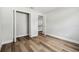 Bright bedroom featuring wood-look floors and closet with bi-fold doors at 930 Balsamina Dr, Brandon, FL 33510