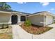Close up of the front entrance features a dark door and manicured landscaping at 930 Balsamina Dr, Brandon, FL 33510