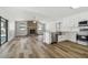 Open kitchen and living room feature stainless appliances and a cozy fireplace, blending style with comfort at 930 Balsamina Dr, Brandon, FL 33510