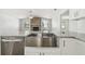 Farmhouse sink with white shaker cabinets and granite countertops in an open kitchen at 930 Balsamina Dr, Brandon, FL 33510