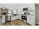 Bright kitchen featuring white cabinetry, stainless steel appliances and granite countertops at 930 Balsamina Dr, Brandon, FL 33510