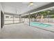 Large screened-in patio with ceiling fans overlooking a backyard swimming pool at 930 Balsamina Dr, Brandon, FL 33510