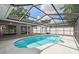 A screened-in pool has a blue interior, steps on one end, and a white tile surround at 930 Balsamina Dr, Brandon, FL 33510