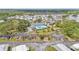 Panoramic aerial view showcases community pool, recreation, verdant landscaping, and convenient parking under a sunny sky at 9790 66Th N St # 160, Pinellas Park, FL 33782