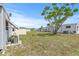 Exterior rear view of property with green grass and mature tree at 9790 66Th N St # 160, Pinellas Park, FL 33782