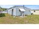 Exterior rear view of property with green grass at 9790 66Th N St # 160, Pinellas Park, FL 33782
