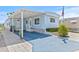 Charming blue home featuring a covered porch, landscaped yard, and inviting curb appeal at 9790 66Th N St # 160, Pinellas Park, FL 33782