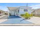 Charming blue home with covered parking, landscaped yard, and inviting curb appeal at 9790 66Th N St # 160, Pinellas Park, FL 33782