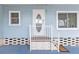 Inviting front entry with oval window door and white railing, offering a charming welcome at 9790 66Th N St # 160, Pinellas Park, FL 33782