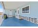 Blue painted covered front porch with plant and outdoor seating area at 9790 66Th N St # 160, Pinellas Park, FL 33782