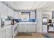 Traditional kitchen with white appliances, cabinetry, and cozy breakfast nook at 9790 66Th N St # 160, Pinellas Park, FL 33782