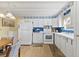 Bright kitchen features white appliances and cabinetry, and lots of storage at 9790 66Th N St # 160, Pinellas Park, FL 33782