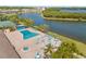 Community pool with chairs and umbrellas, surrounded by palm trees at 9950 62Nd N Ter # 316, St Petersburg, FL 33708