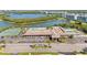 Aerial view of community clubhouse with tennis and pool by the water at 9950 62Nd N Ter # 316, St Petersburg, FL 33708