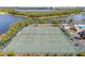 Aerial view of community tennis courts near a lake and community pool at 9950 62Nd N Ter # 316, St Petersburg, FL 33708