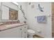 Bathroom features a marble vanity and decorative seabird art at 9950 62Nd N Ter # 316, St Petersburg, FL 33708