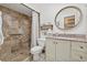 Bathroom with tiled walk-in shower, vanity, toilet, and decorative fixtures and accents at 9950 62Nd N Ter # 316, St Petersburg, FL 33708