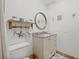The bathroom features a vanity, toilet, walk-in shower, and beach-themed decor at 9950 62Nd N Ter # 316, St Petersburg, FL 33708