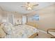 This bedroom is decorated with neutral walls, ceiling fan, and coastal-themed decor at 9950 62Nd N Ter # 316, St Petersburg, FL 33708