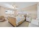 This bedroom features neutral walls, a decorative ceiling fan, and wicker furniture at 9950 62Nd N Ter # 316, St Petersburg, FL 33708