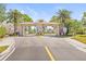 Inviting community entrance featuring palm trees and gate with 'Resident' and 'Guest' signage at 9950 62Nd N Ter # 316, St Petersburg, FL 33708