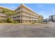 Multi-story condo building with spacious balconies, green spaces and covered parking at 9950 62Nd N Ter # 316, St Petersburg, FL 33708