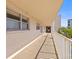 Exterior condo hallway features textured walls, railings, and views of tropical foliage at 9950 62Nd N Ter # 316, St Petersburg, FL 33708
