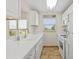 Bright kitchen with white cabinets, tile backsplash, and stainless steel appliances at 9950 62Nd N Ter # 316, St Petersburg, FL 33708