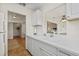 Kitchen with white cabinets and appliances, open to the dining and living areas at 9950 62Nd N Ter # 316, St Petersburg, FL 33708