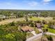 Aerial view of home with nearby golf course and surrounding trees at 5202 Lydia Ct, Spring Hill, FL 34608