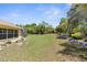 Large backyard with a retaining wall and garden bed at 5202 Lydia Ct, Spring Hill, FL 34608