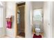 Bathroom showcasing the shower and toilet area, with a window above the toilet at 5202 Lydia Ct, Spring Hill, FL 34608