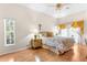 Light-filled bedroom with hardwood floors, floral bedding, decorative window treatments, and ample natural light at 5202 Lydia Ct, Spring Hill, FL 34608