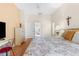 Comfortable bedroom featuring hardwood floors, floral bedding, and soft lighting from bedside lamps at 5202 Lydia Ct, Spring Hill, FL 34608