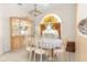 Dining room featuring elegant chandelier lighting, tile floors, and a decorative cabinet at 5202 Lydia Ct, Spring Hill, FL 34608