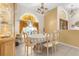 Charming dining room featuring a classic chandelier, tile floors, and a decorative window at 5202 Lydia Ct, Spring Hill, FL 34608